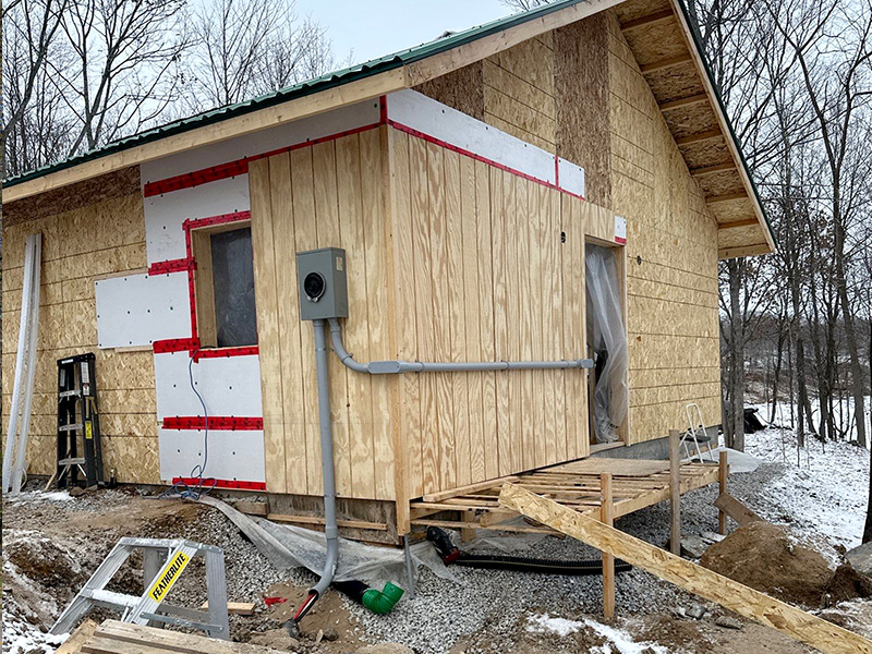 Wide exterior view of the new rural structure with private power service infrastructure