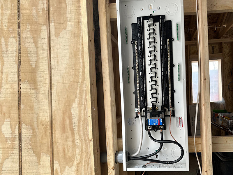 Interior electrical panel infrastructure inside a framed new rural structure